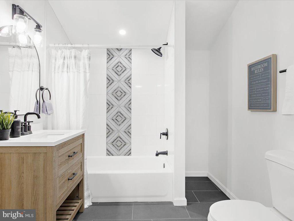 313 North Hammonds Ferry Road Linthicum Heights, MD 21090 - Photo 22 of 39 a bathroom with a sink a toilet and a bathtub