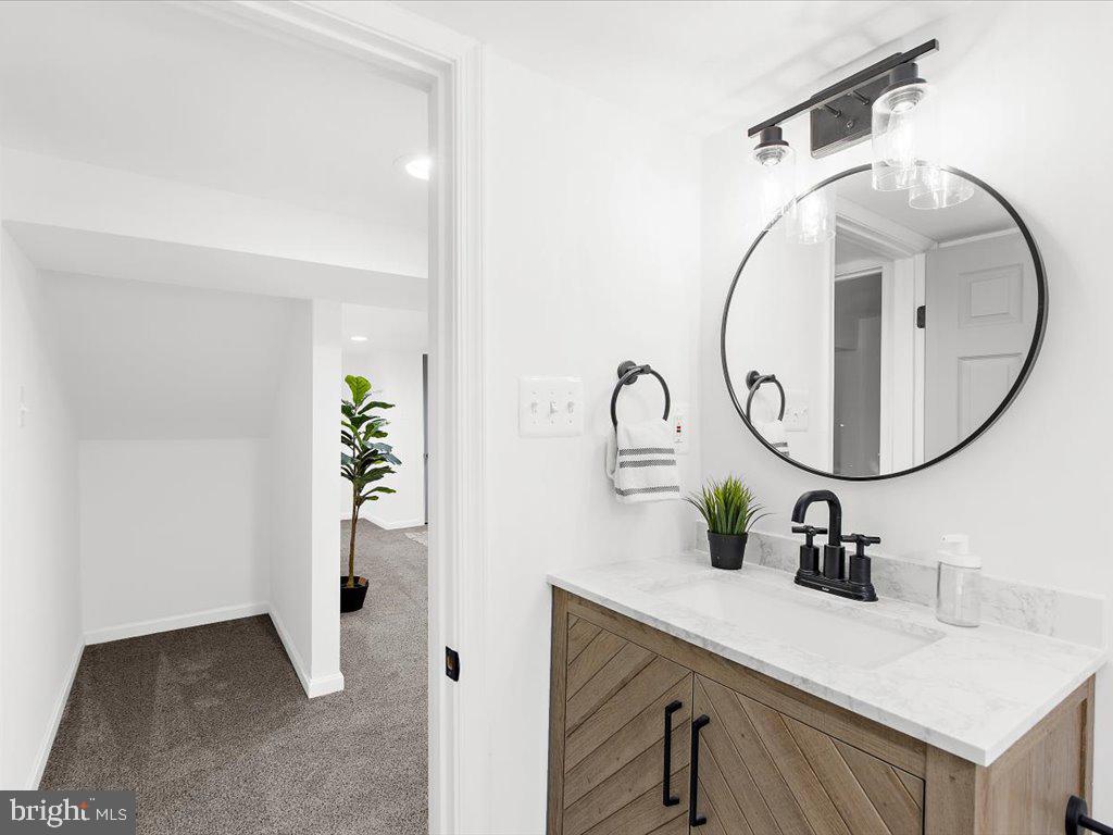 313 North Hammonds Ferry Road Linthicum Heights, MD 21090 - Photo 34 of 39 a bathroom with a sink and a mirror