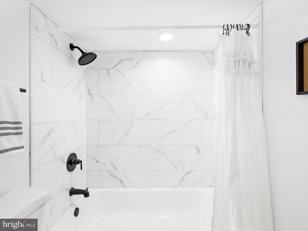 313 North Hammonds Ferry Road Linthicum Heights, MD 21090 - Photo 35 of 39 a bathroom with a shower and a bath tub