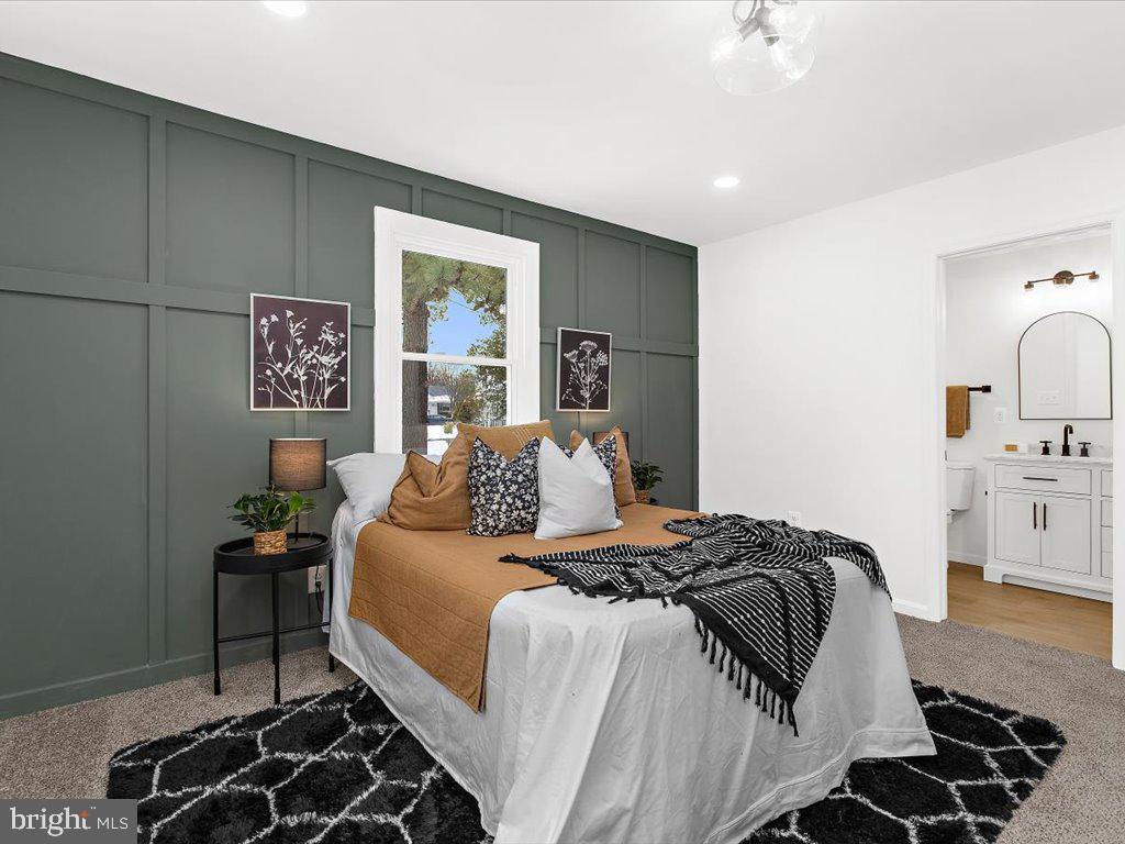 313 North Hammonds Ferry Road Linthicum Heights, MD 21090 - Photo 6 of 39 a bedroom with a bed and a lamp on dresser