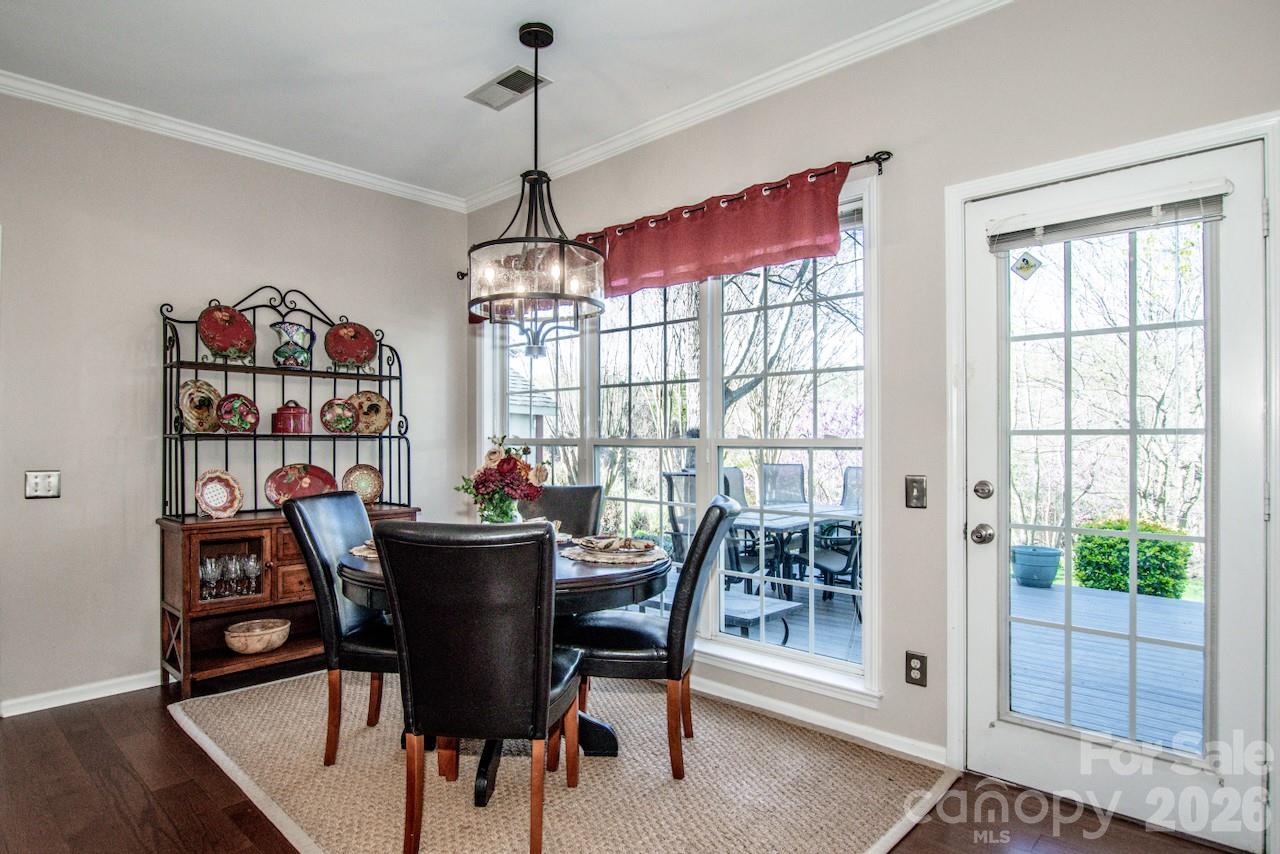 150 Coronilla Road Mooresville, NC 28117 - Photo 14 of 39 a dining room with furniture a chandelier and wooden floor