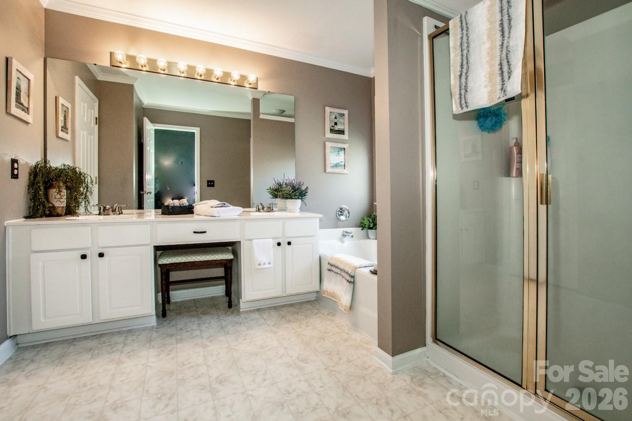150 Coronilla Road Mooresville, NC 28117 - Photo 19 of 39 a bathroom with a double vanity sink a mirror and a shower