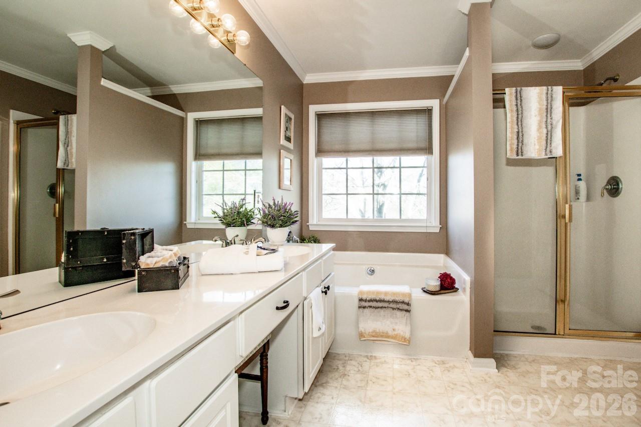 150 Coronilla Road Mooresville, NC 28117 - Photo 20 of 39 a bathroom with a tub sink and mirror