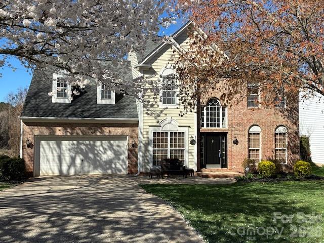 150 Coronilla Road Mooresville, NC 28117 - Photo 2 of 39 a front view of a house with a garden