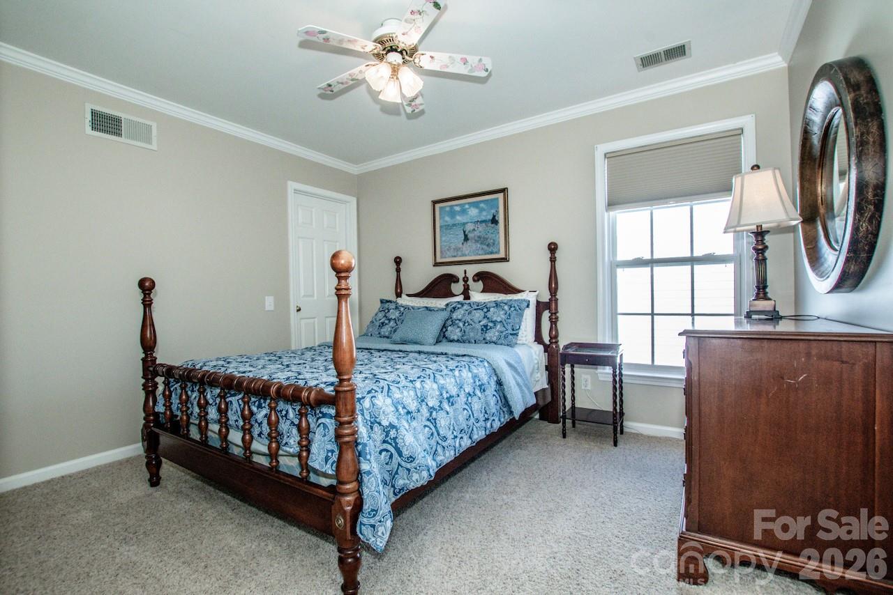 150 Coronilla Road Mooresville, NC 28117 - Photo 24 of 39 a bed room with a bed window and a chair