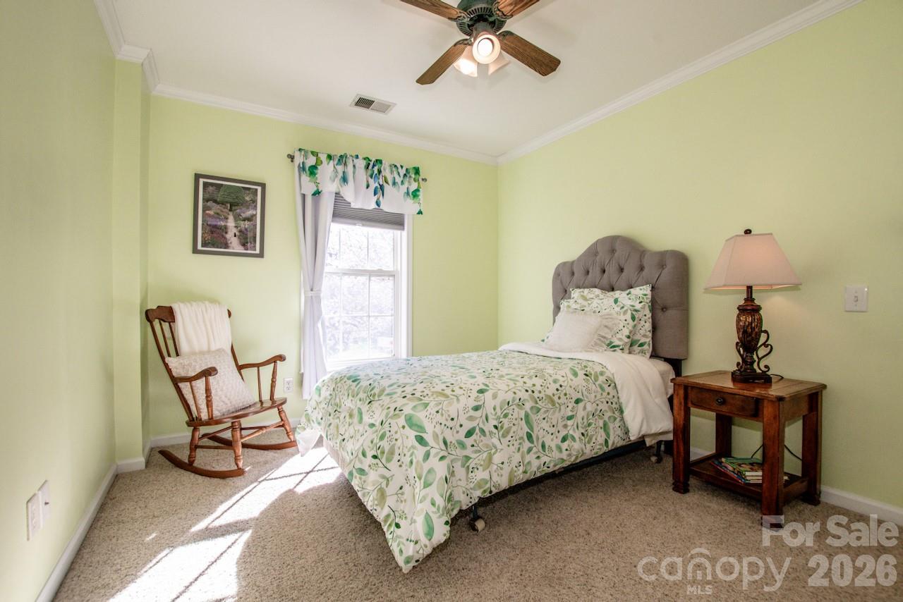 150 Coronilla Road Mooresville, NC 28117 - Photo 26 of 39 a bedroom with a bed a chair and the potted plant