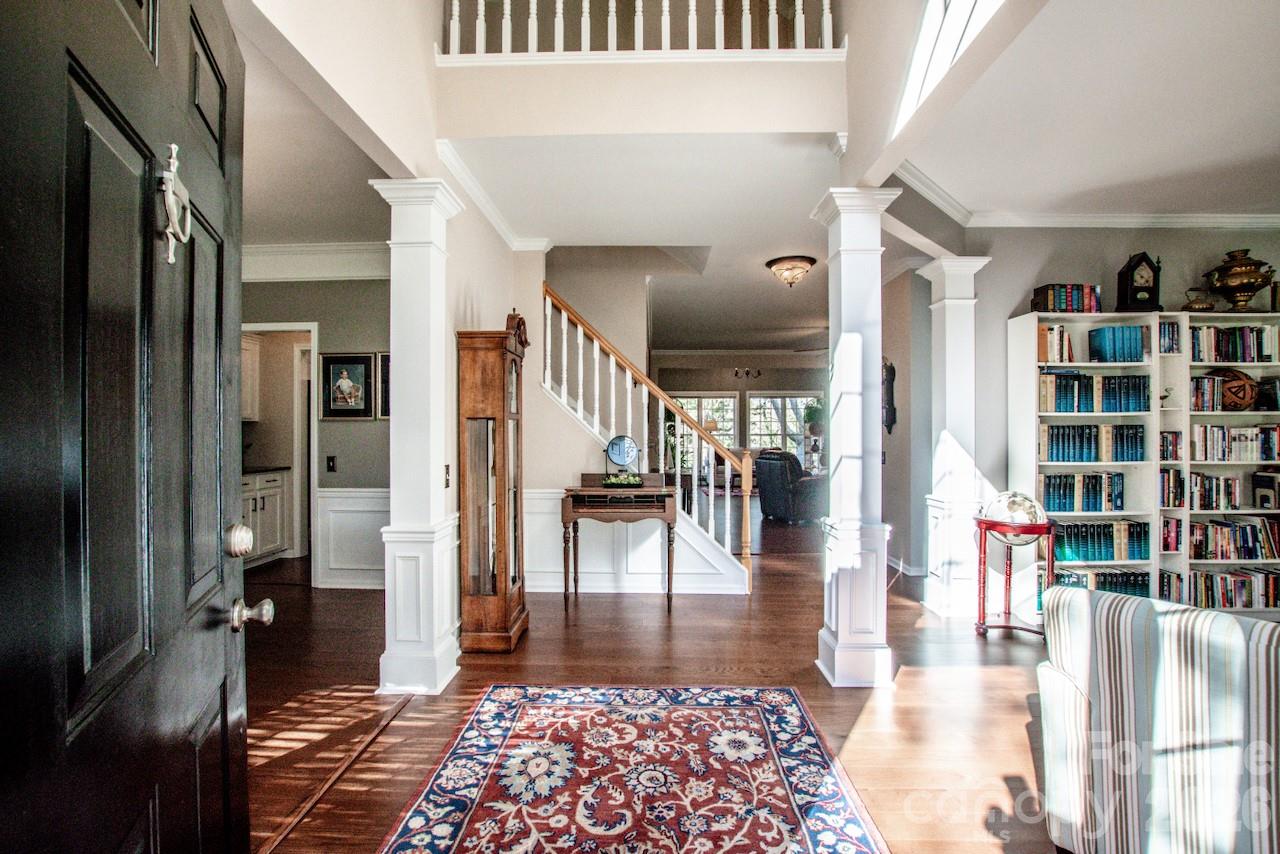 150 Coronilla Road Mooresville, NC 28117 - Photo 3 of 39 a view of a hallway with wooden floor and furniture