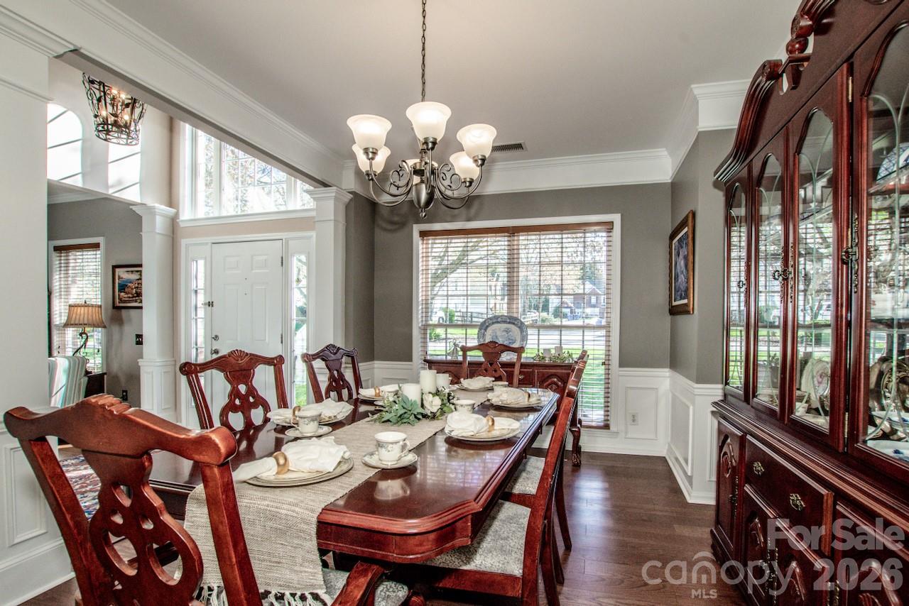 150 Coronilla Road Mooresville, NC 28117 - Photo 9 of 39 a view of a dining room with furniture wooden floor and chandelier