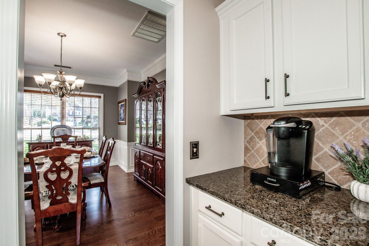150 Coronilla Road Mooresville, NC 28117 - Photo 10 of 39 a view of a dining room with furniture window and wooden floor