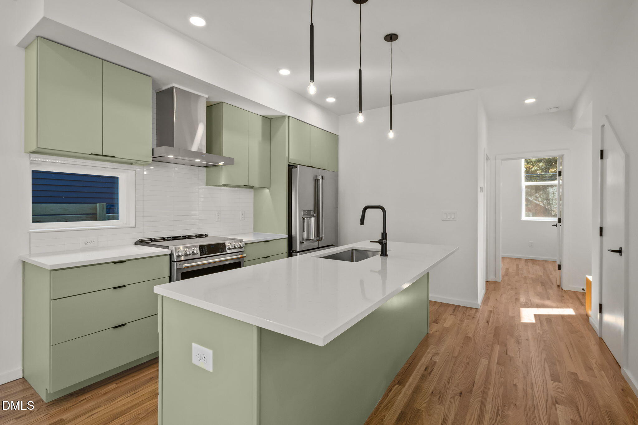 1605 Glendale Avenue Durham, NC 27701 - Photo 11 of 41 a large kitchen with stainless steel appliances a large counter top a stove a chimney a sink and a refrigerator
