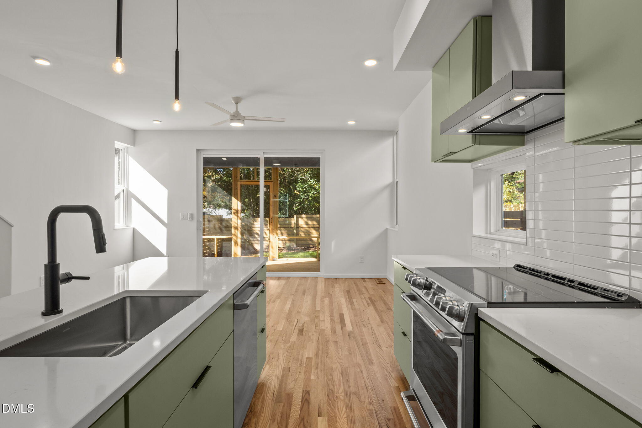 1605 Glendale Avenue Durham, NC 27701 - Photo 12 of 41 a kitchen with stainless steel appliances granite countertop a sink a stove and a wooden floors