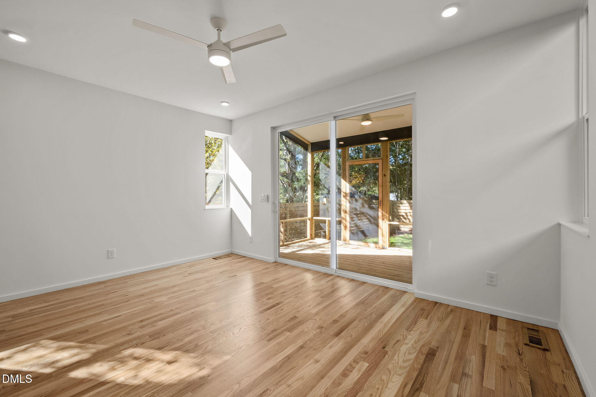 1605 Glendale Avenue Durham, NC 27701 - Photo 14 of 41 a view of an empty room with wooden floor and a window