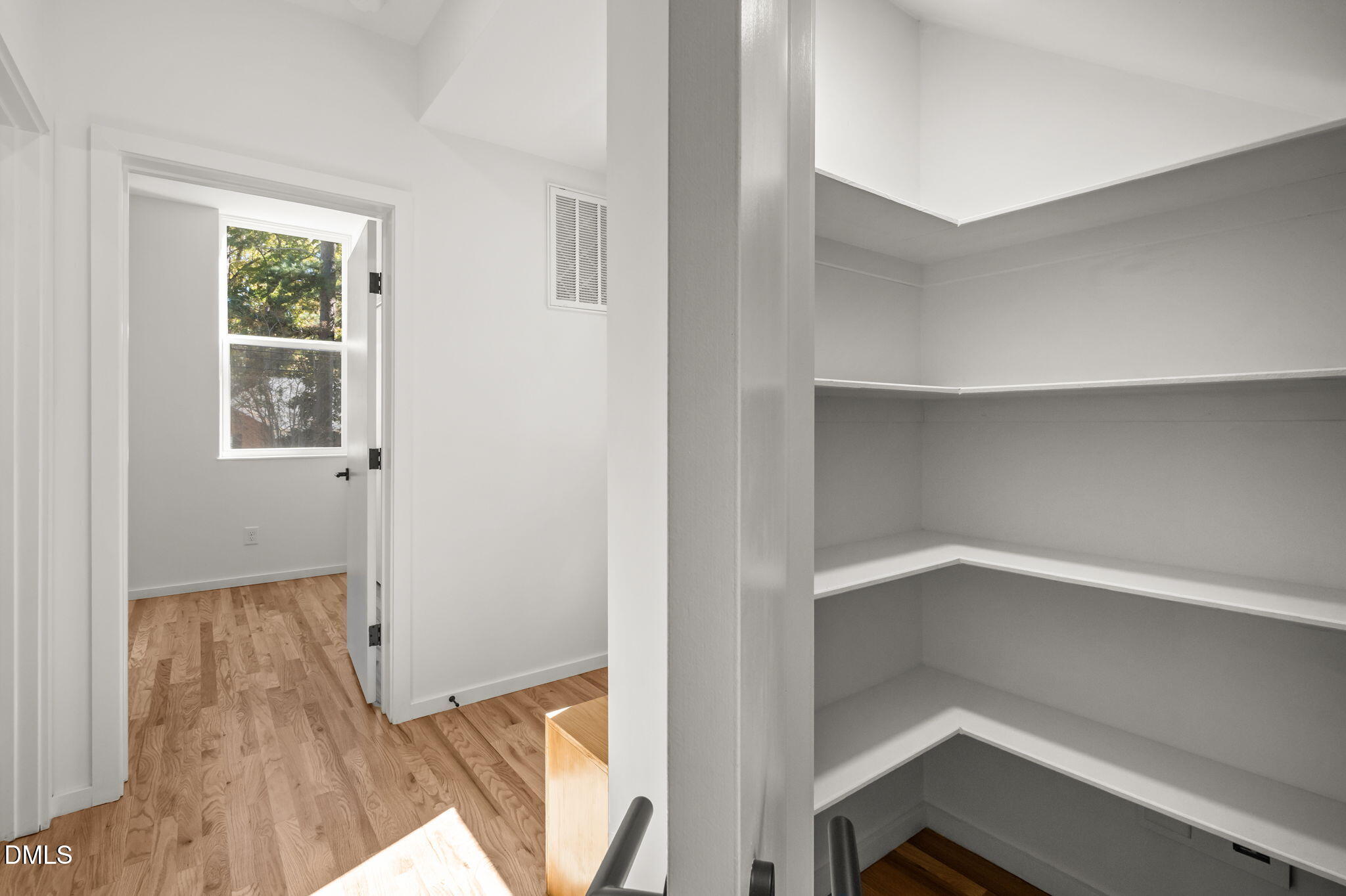 1605 Glendale Avenue Durham, NC 27701 - Photo 17 of 41 a view of an empty room with wooden floor and a window
