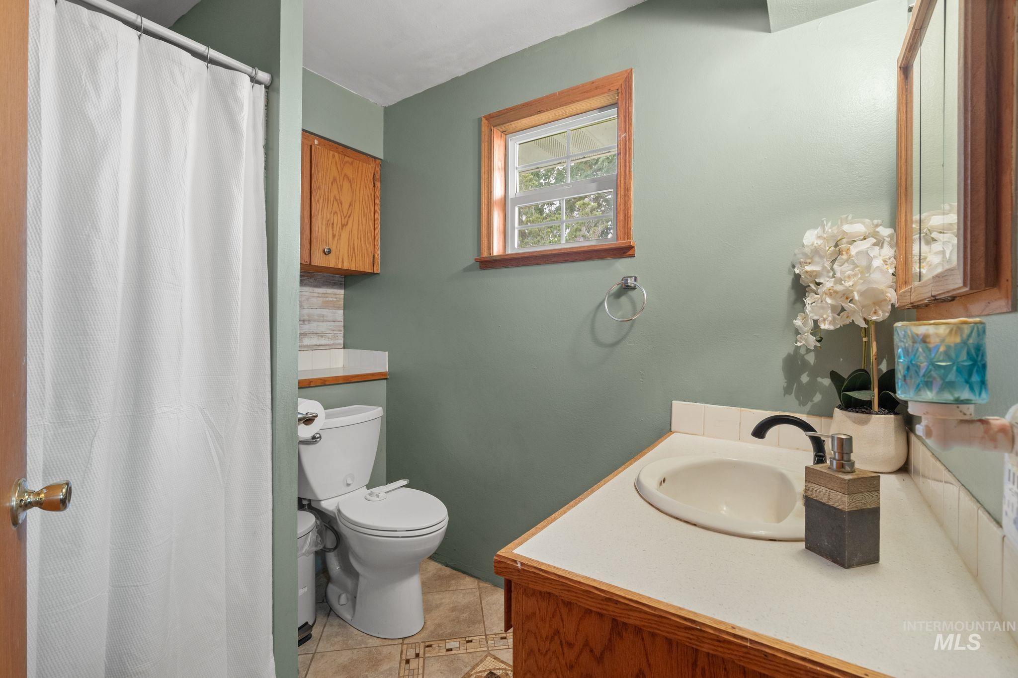 2119 Ripon Avenue Lewiston, ID 83501 - Photo 26 of 50 Bathroom featuring a vanity with a drop-in sink, wood-finish cabinetry, and a framed mirror