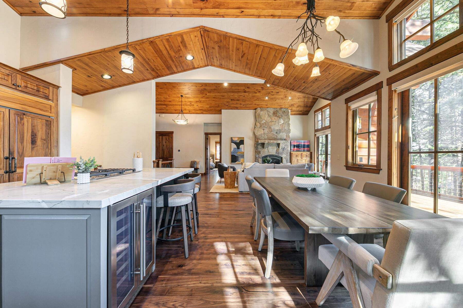 11541 Bottcher Loop Truckee, CA 96161 - Photo 11 of 28 a large kitchen with stainless steel appliances granite countertop a large kitchen island a stove a sink a dining table and chairs with wooden floor