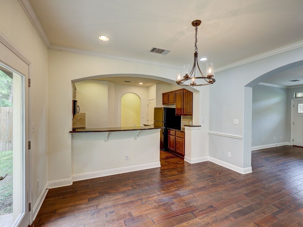 6708 Menchaca Road, Unit 7 Austin, TX 78745 - Photo 11 of 32 a view of a room with wooden floor a chandelier and window