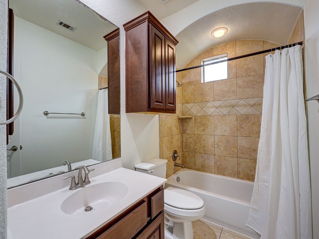 6708 Menchaca Road, Unit 7 Austin, TX 78745 - Photo 18 of 32 a bathroom with a sink a toilet and shower