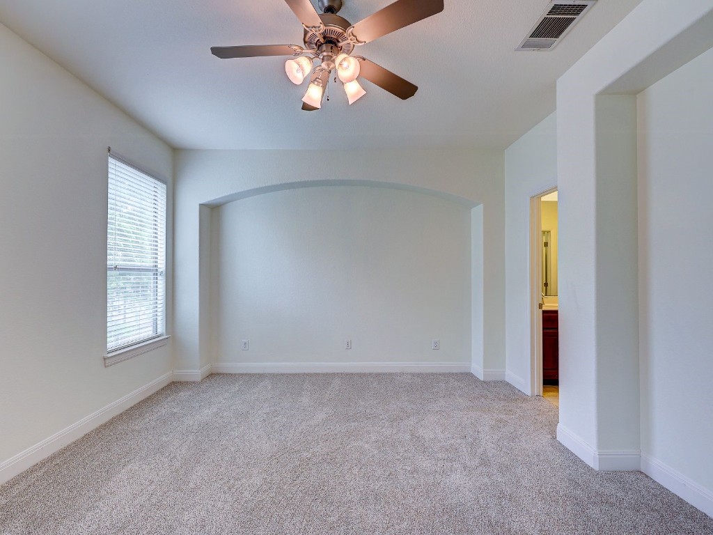 6708 Menchaca Road, Unit 7 Austin, TX 78745 - Photo 22 of 32 an empty room with windows and fan