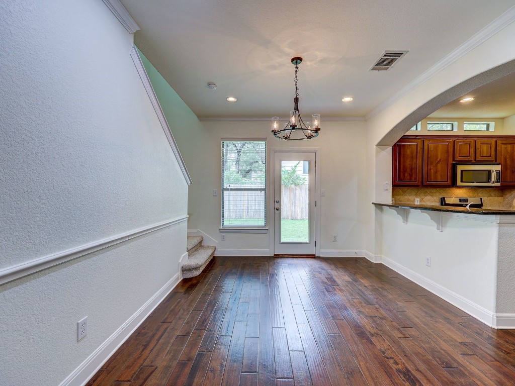 6708 Menchaca Road, Unit 7 Austin, TX 78745 - Photo 9 of 32 a view of a kitchen with wooden floor and a window