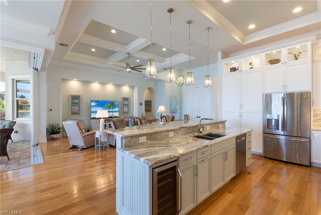 18018 Broadview Drive Naples, FL 34114 - Photo 11 of 46 a kitchen with stainless steel appliances granite countertop a sink and a refrigerator