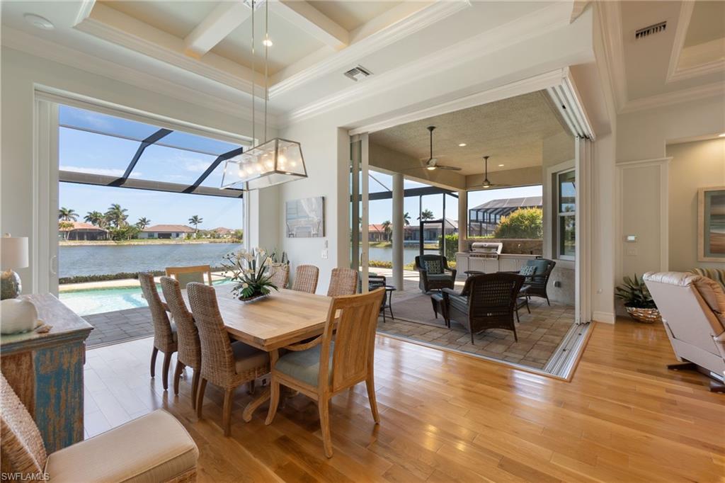 18018 Broadview Drive Naples, FL 34114 - Photo 14 of 46 a dining room with furniture window and wooden floor