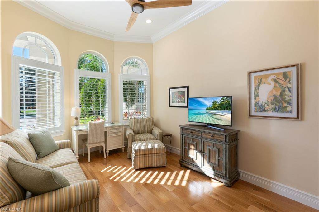 18018 Broadview Drive Naples, FL 34114 - Photo 16 of 46 a living room with furniture a flat screen tv and a large window