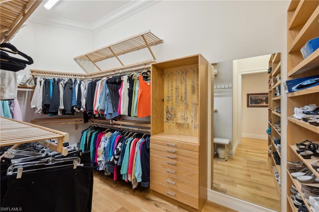 18018 Broadview Drive Naples, FL 34114 - Photo 19 of 46 a view of walk in closet with clothes and shoes