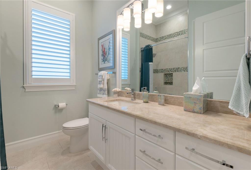 18018 Broadview Drive Naples, FL 34114 - Photo 24 of 46 a bathroom with a granite countertop sink and a mirror