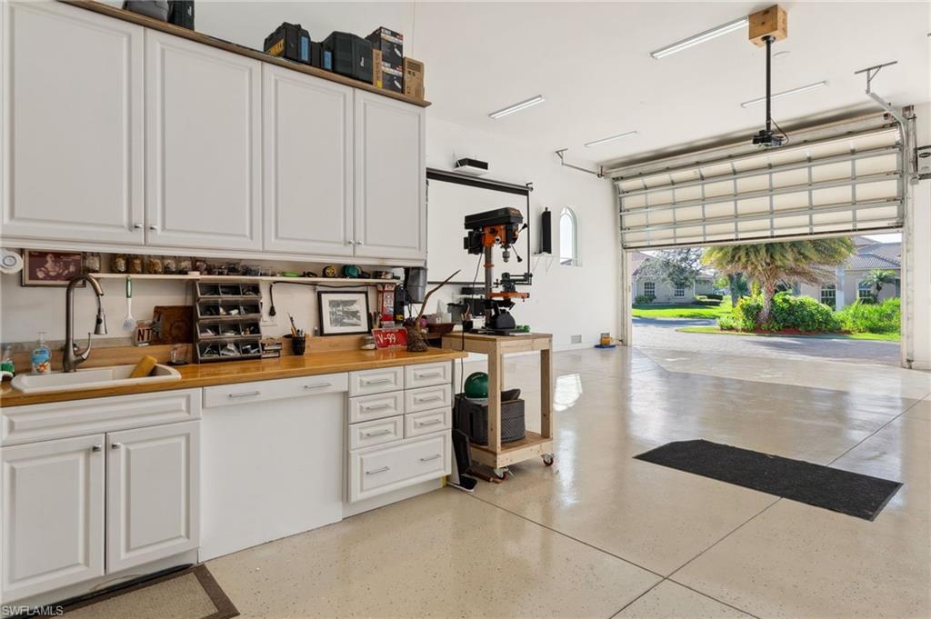 18018 Broadview Drive Naples, FL 34114 - Photo 29 of 46 a kitchen with white cabinets and window