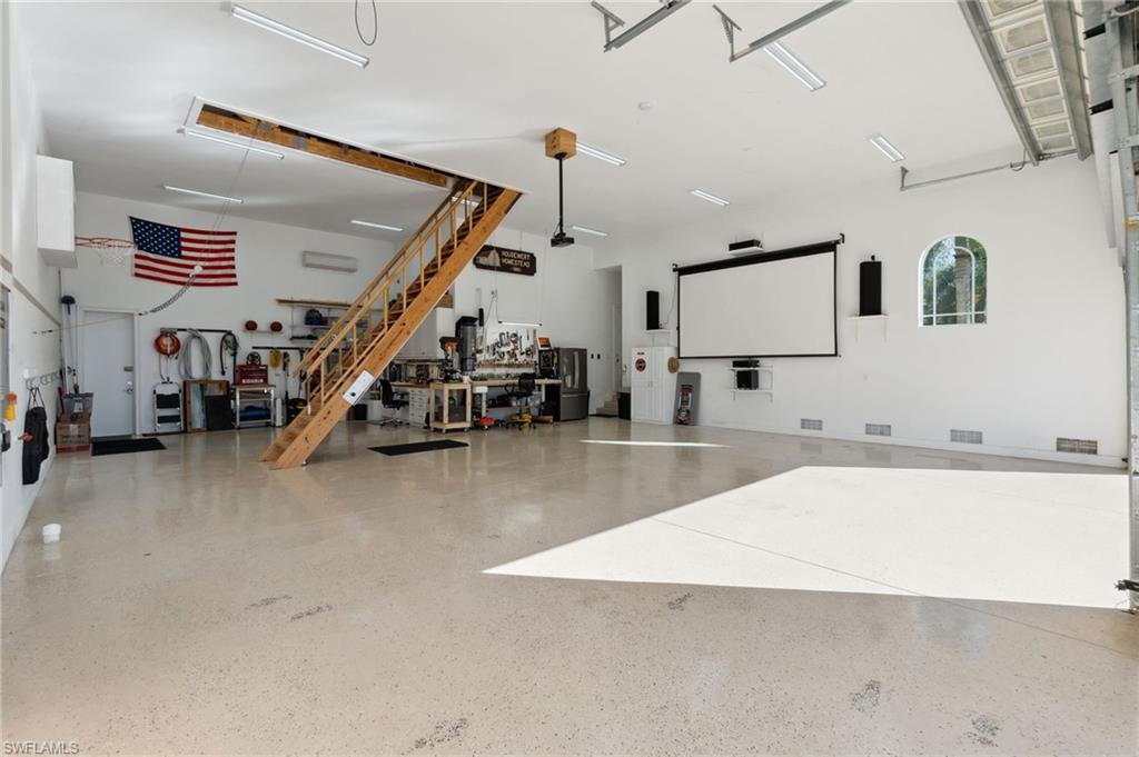18018 Broadview Drive Naples, FL 34114 - Photo 32 of 46 a view of a kitchen with furniture and a flat screen tv
