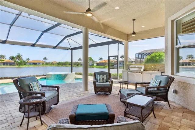 a living room with furniture and a floor to ceiling windows