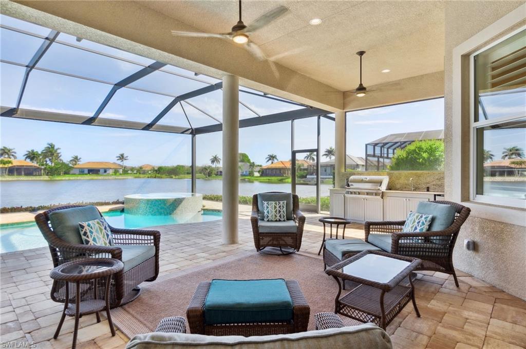 18018 Broadview Drive Naples, FL 34114 - Photo 34 of 46 a living room with furniture and a floor to ceiling windows