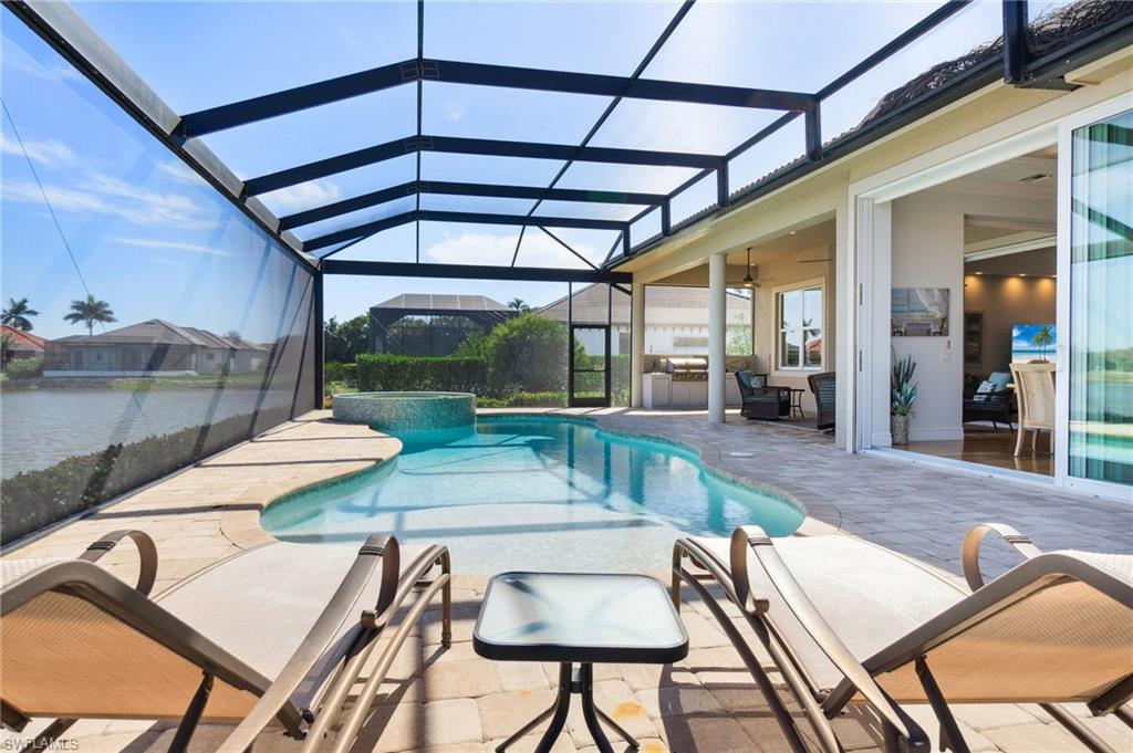 18018 Broadview Drive Naples, FL 34114 - Photo 38 of 46 a view of a patio with a table and chairs