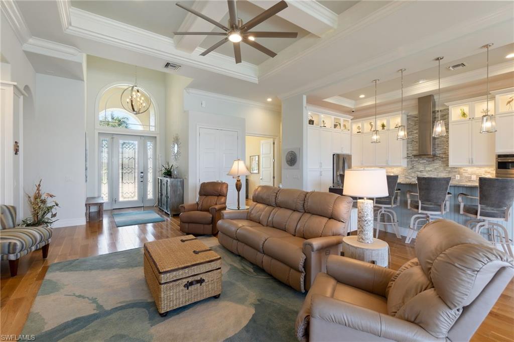 18018 Broadview Drive Naples, FL 34114 - Photo 8 of 46 a living room with furniture and a large window