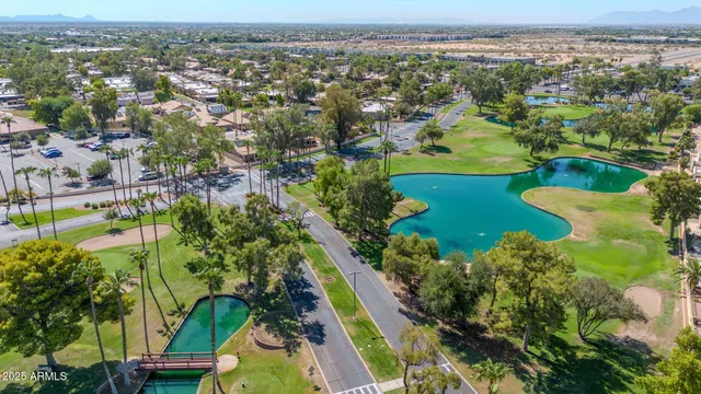 an aerial view of residential houses with outdoor space and river