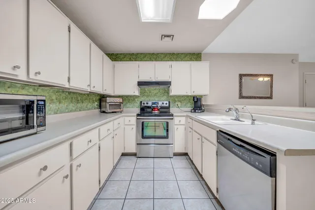 a kitchen with granite countertop a sink and cabinets