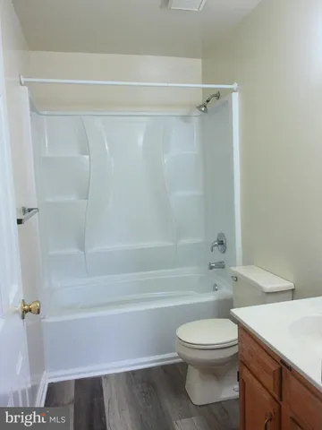 a bathroom with a toilet and a bath tub