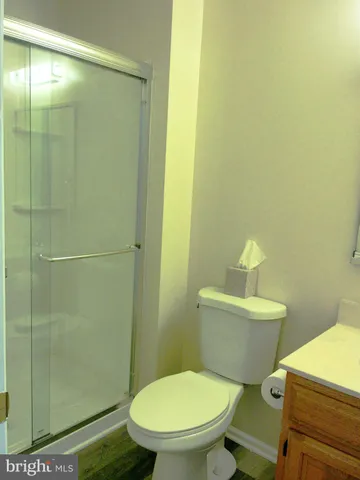 a white toilet sitting next to a bathroom sink