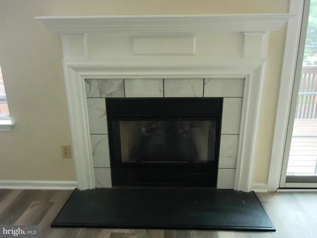 a living room with a fireplace and a window