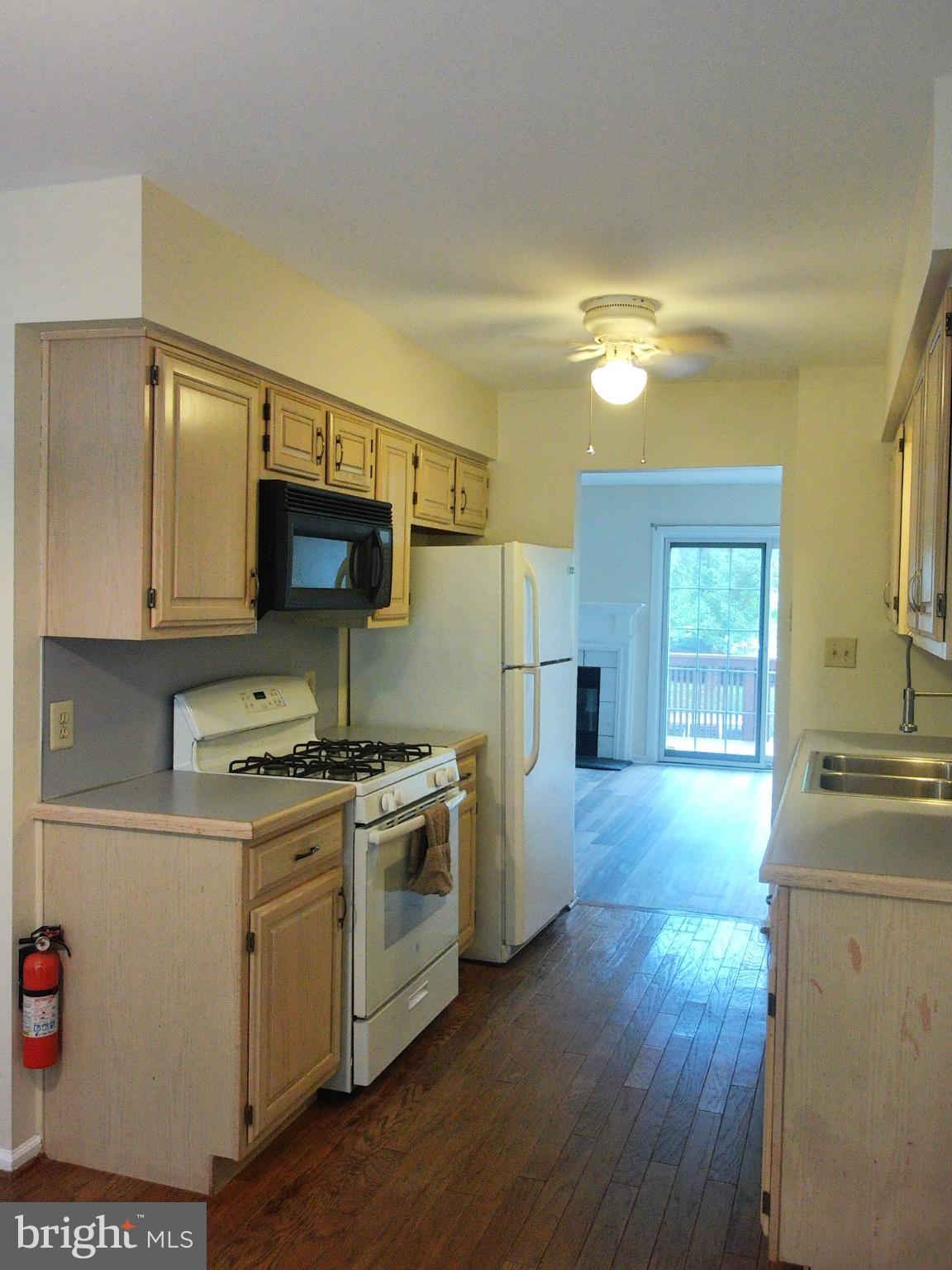 857 Jackson Street Lansdale, PA 19446 - Photo 8 of 22 a kitchen with a stove a sink and a refrigerator
