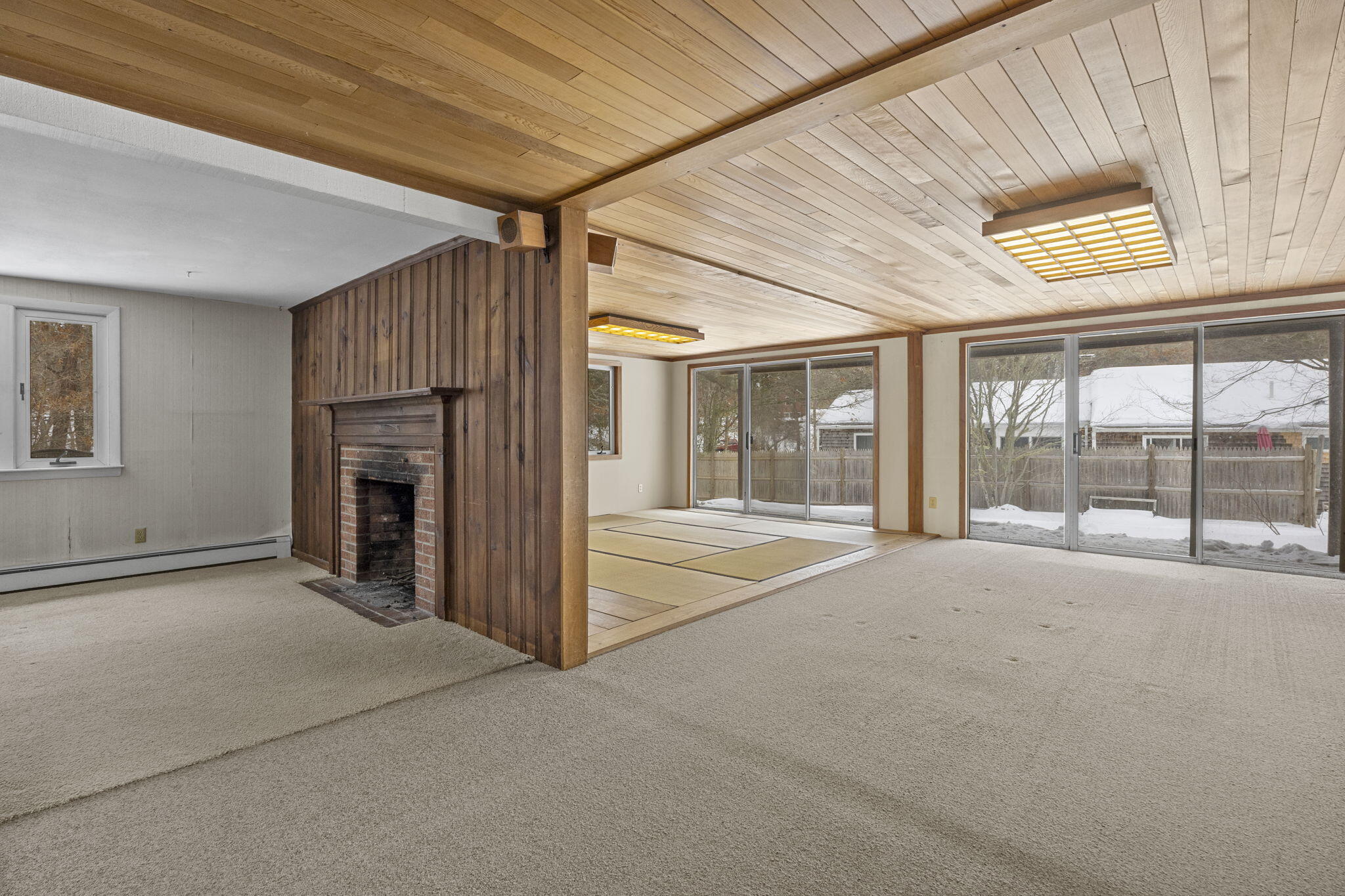 58 Aunt Molls Ridge Brewster, MA 02631 - Photo 14 of 53 a view of an empty room with a fireplace and a window
