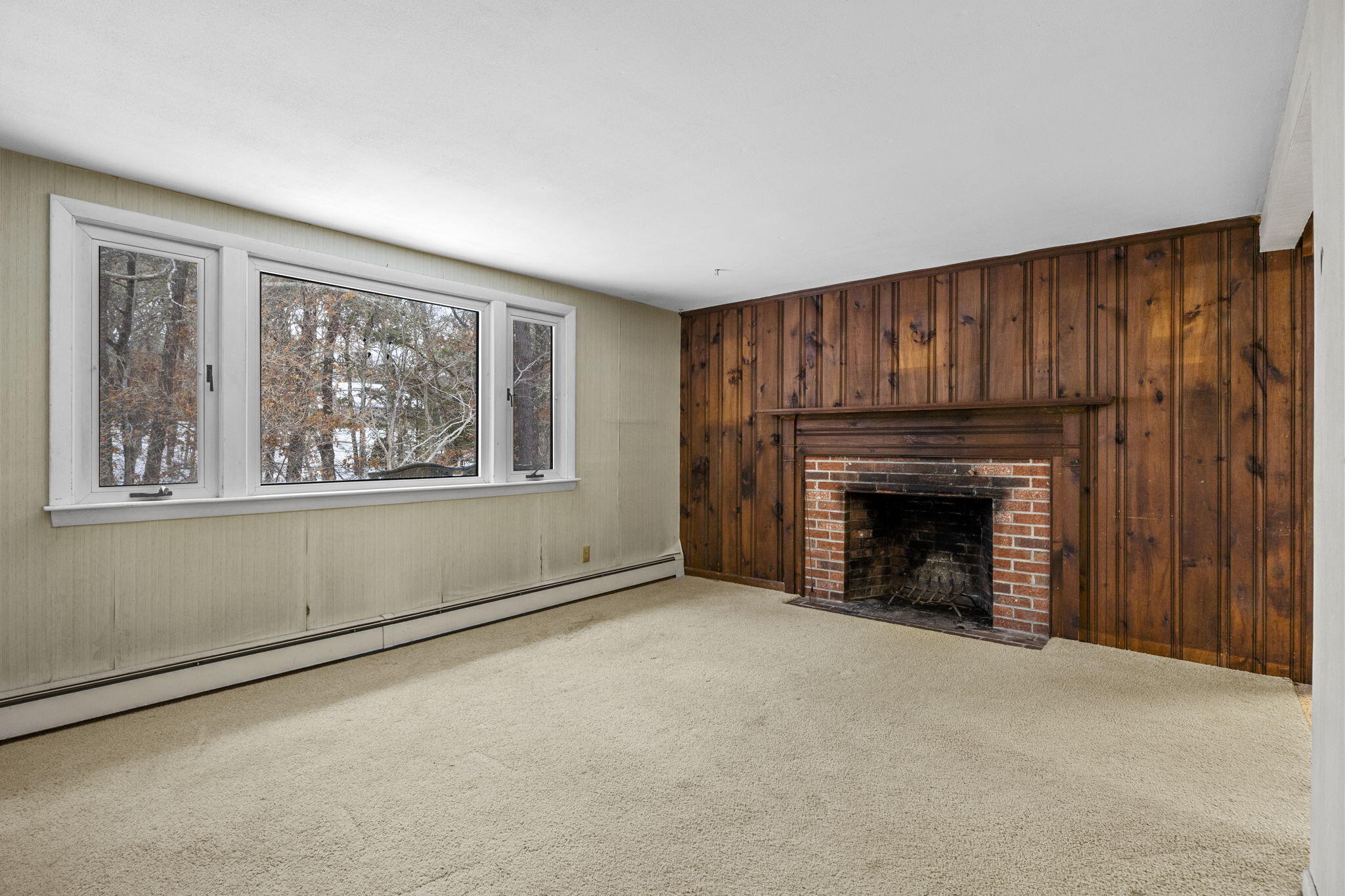 58 Aunt Molls Ridge Brewster, MA 02631 - Photo 6 of 53 a view of an empty room with a fireplace and a window