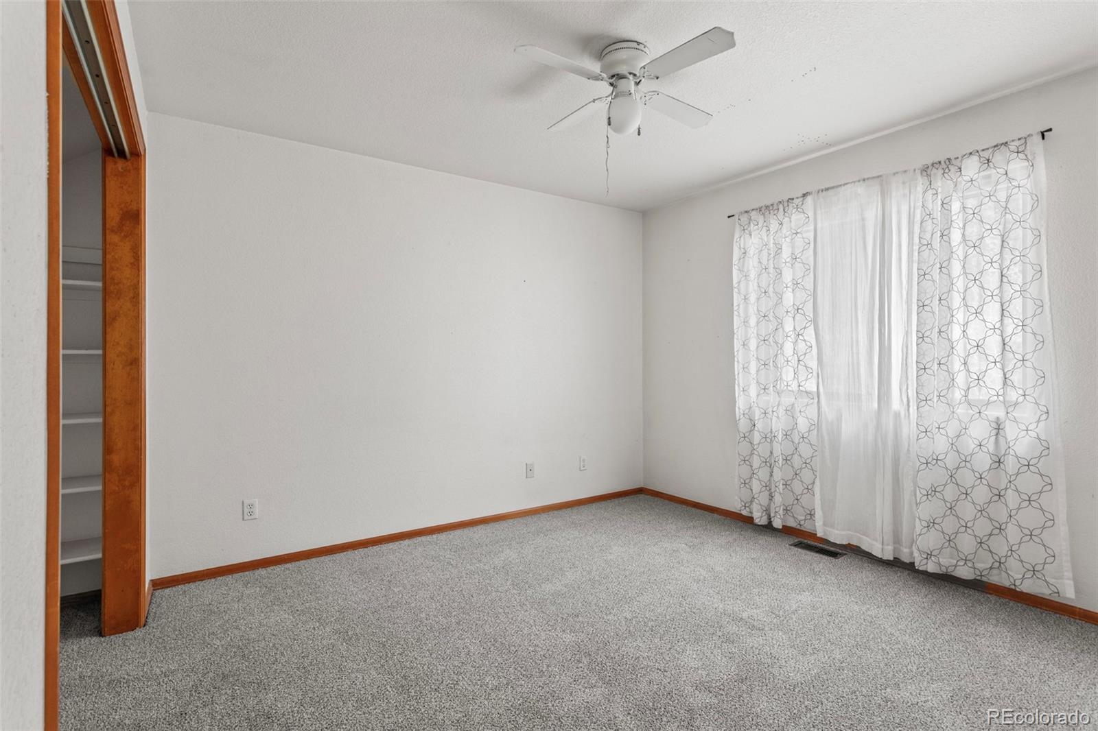 12183 Arnett Ranch Road Littleton, CO 80127 - Photo 18 of 28 wooden floor in an empty room with a window