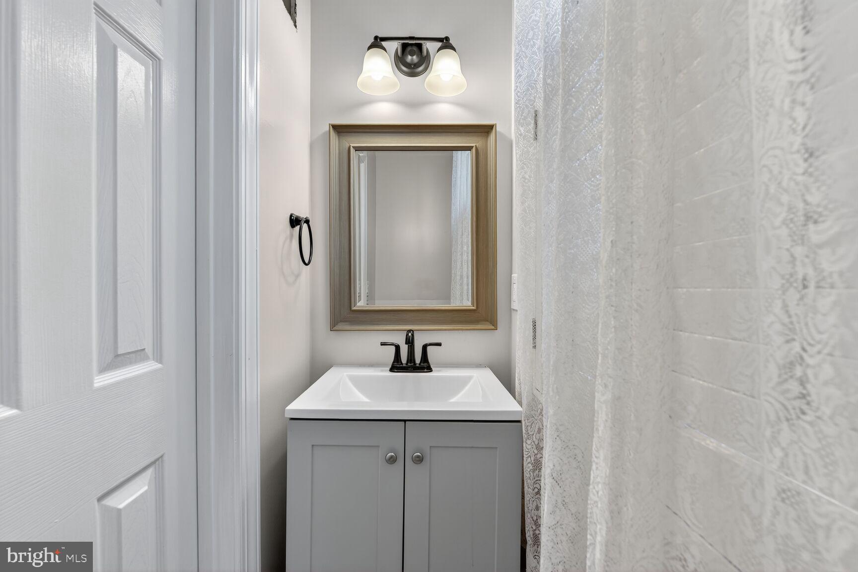 20970 Promontory Square Sterling, VA 20165 - Photo 14 of 44 a bathroom with a sink and a mirror