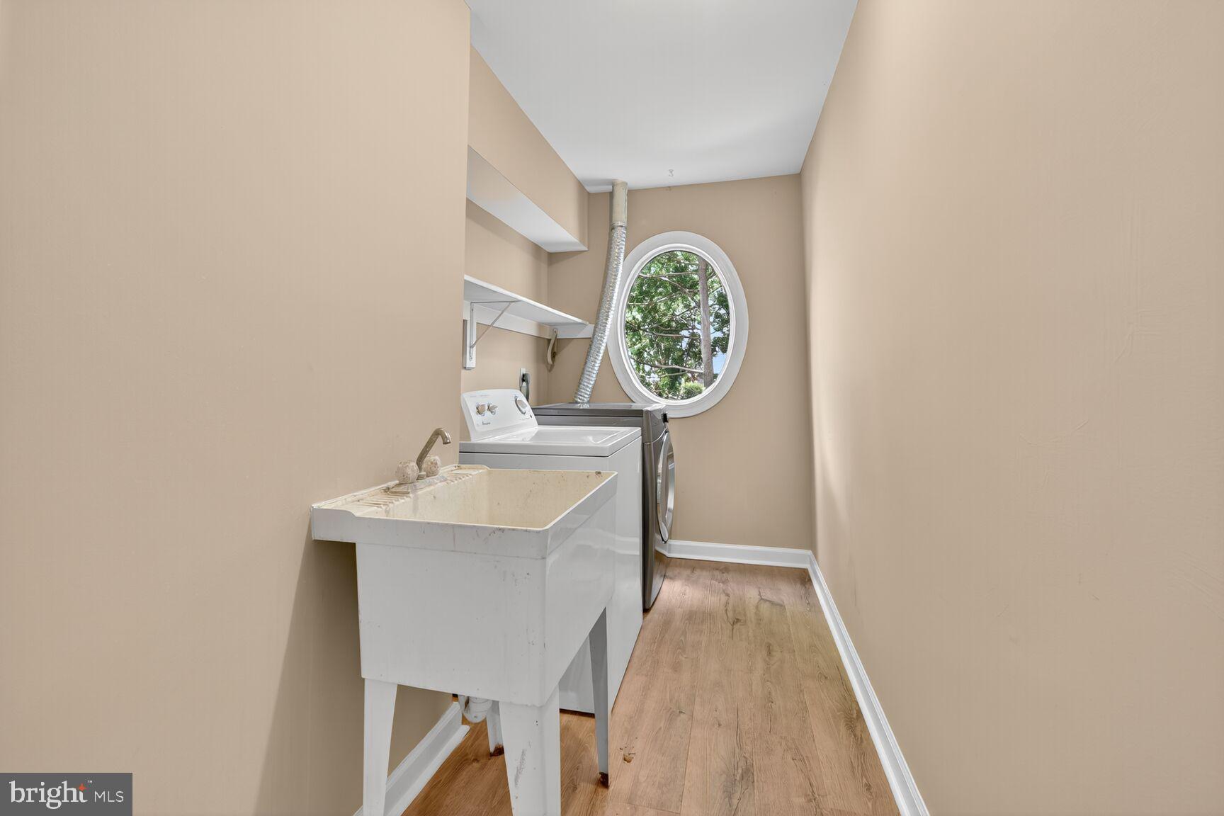 20970 Promontory Square Sterling, VA 20165 - Photo 31 of 44 a view of a hallway with a sink and a clock on th wall