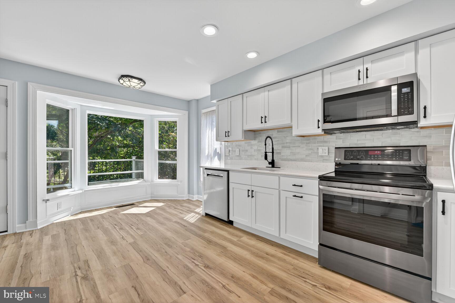 20970 Promontory Square Sterling, VA 20165 - Photo 4 of 44 a kitchen with stainless steel appliances granite countertop a stove and a sink