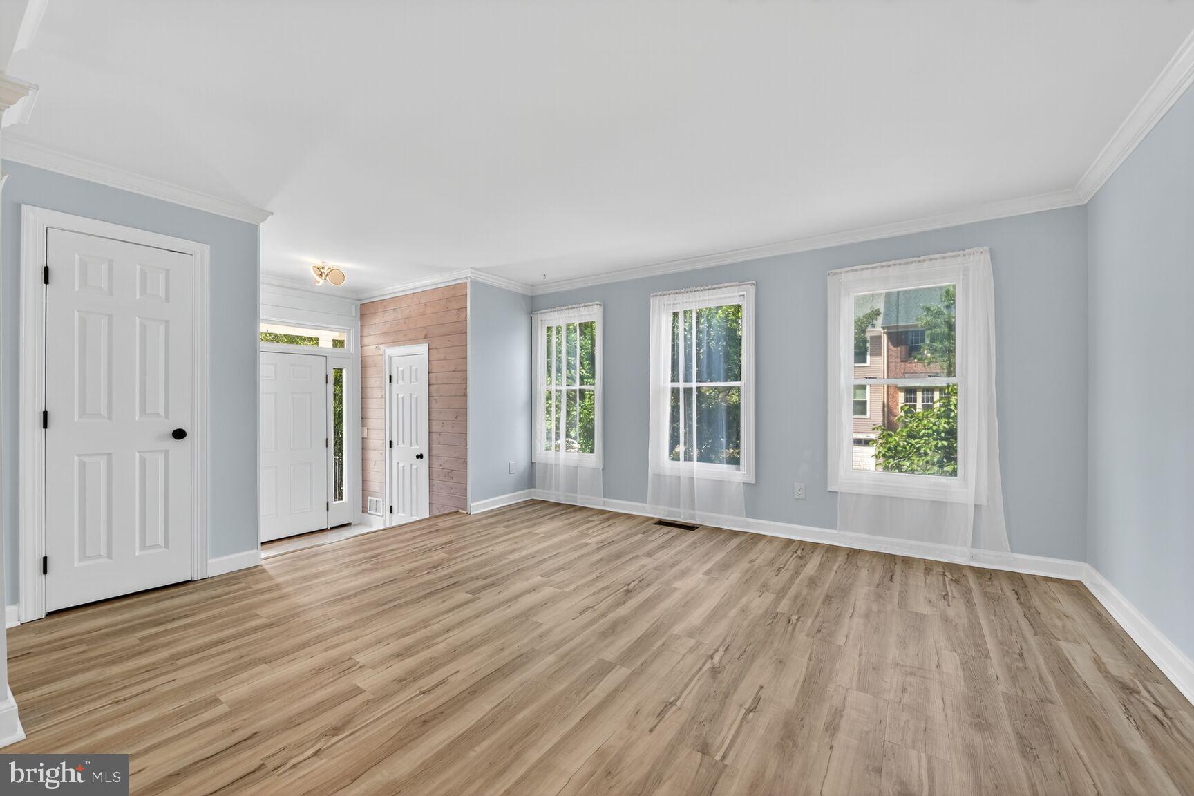 20970 Promontory Square Sterling, VA 20165 - Photo 9 of 44 a view of an empty room with wooden floor and a window