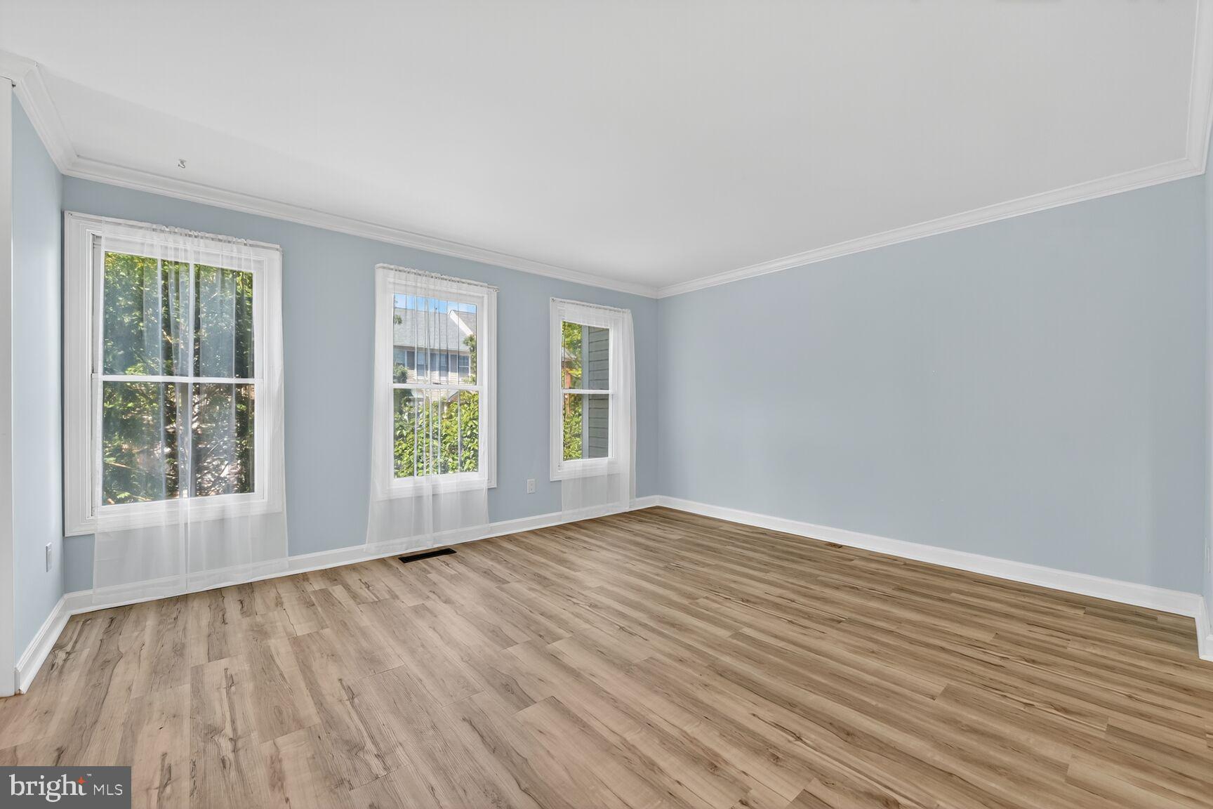 20970 Promontory Square Sterling, VA 20165 - Photo 10 of 44 a view of an empty room with wooden floor and a window
