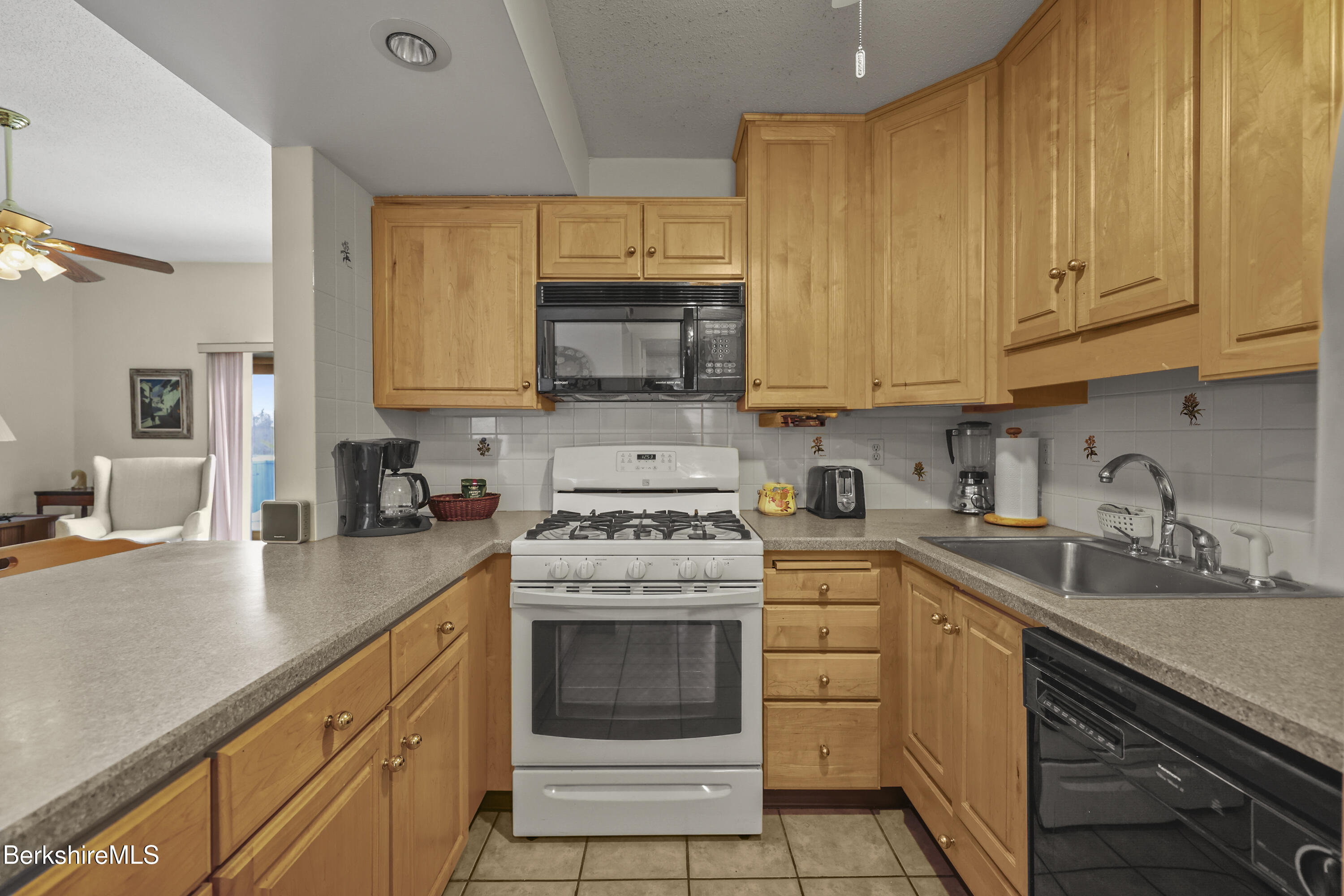 7 Rolling Hills, Unit 71 Lenox, MA 01240 - Photo 11 of 47 a kitchen with granite countertop white cabinets sink and stainless steel appliances