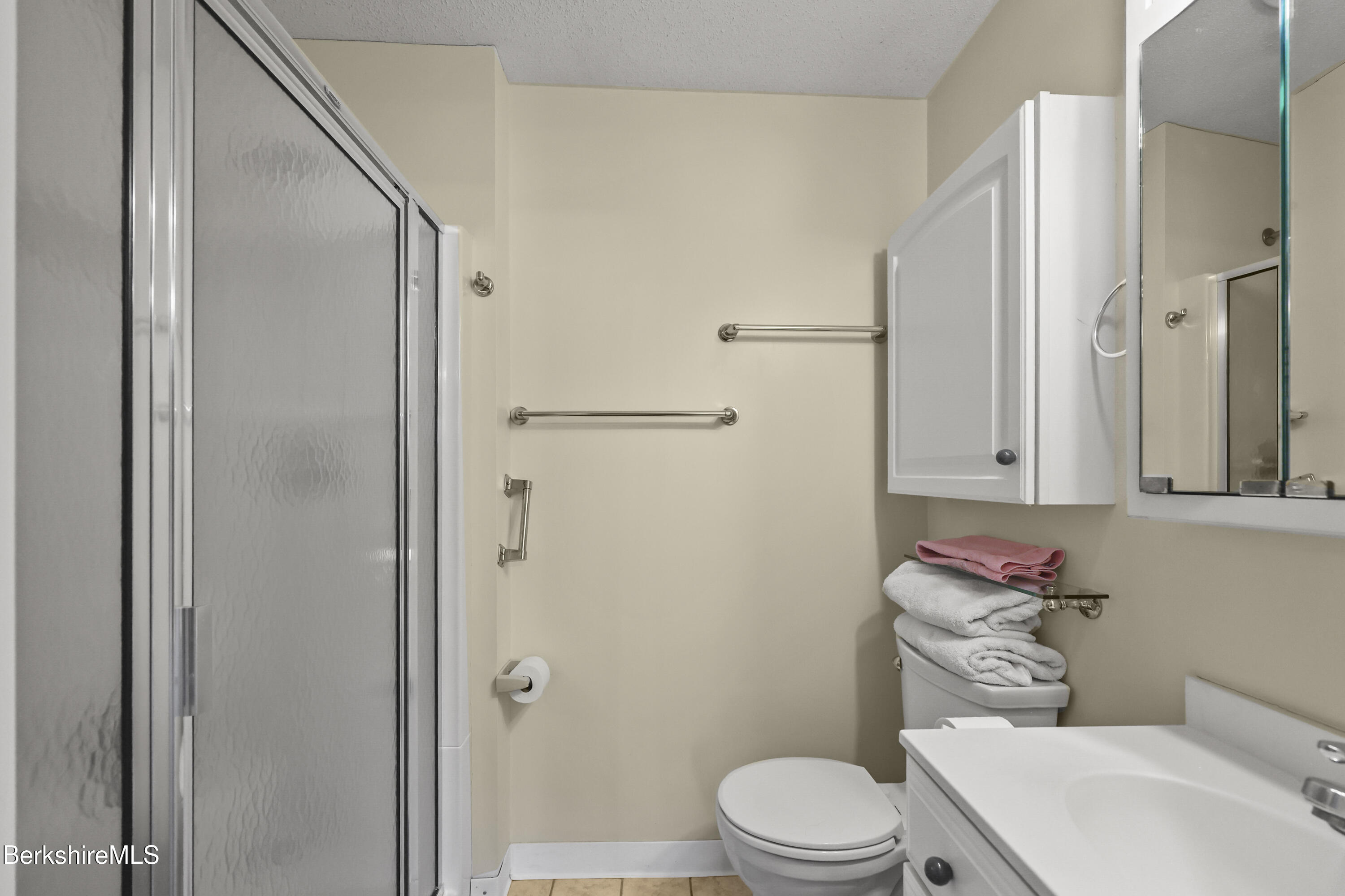 7 Rolling Hills, Unit 71 Lenox, MA 01240 - Photo 17 of 47 a white toilet sitting next to a bathroom sink